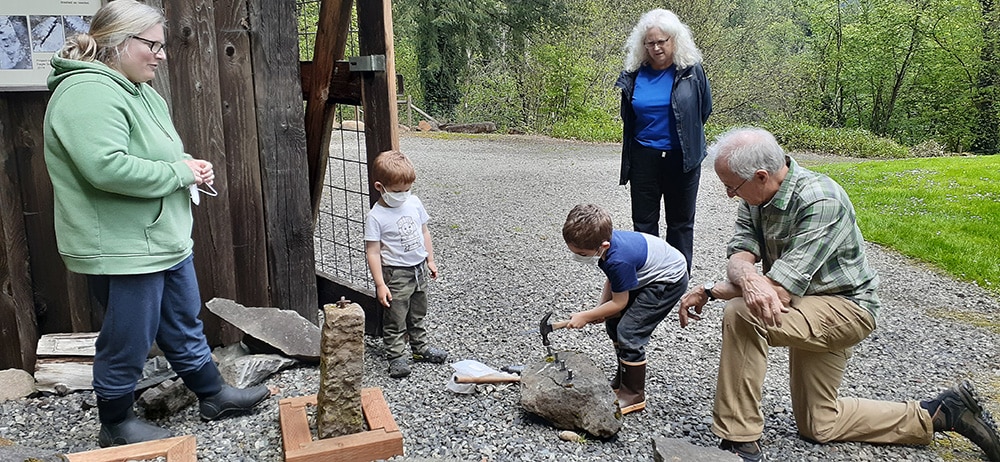 Kids splitting rocks at the Baker Cabin