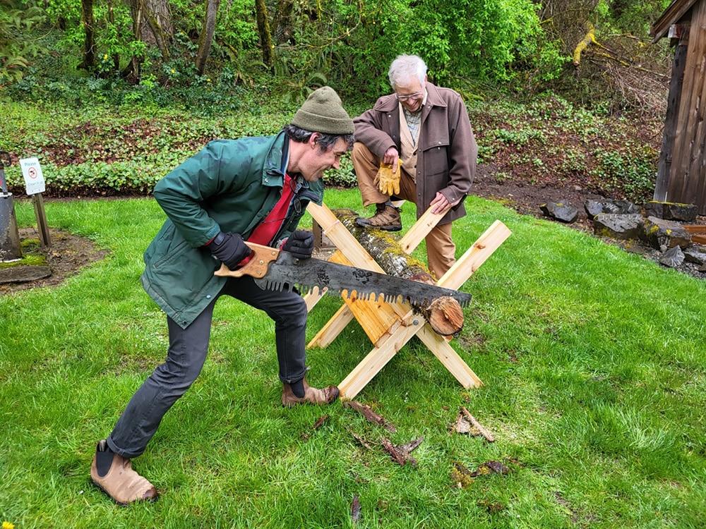 sawing wood at the Baker Cabin