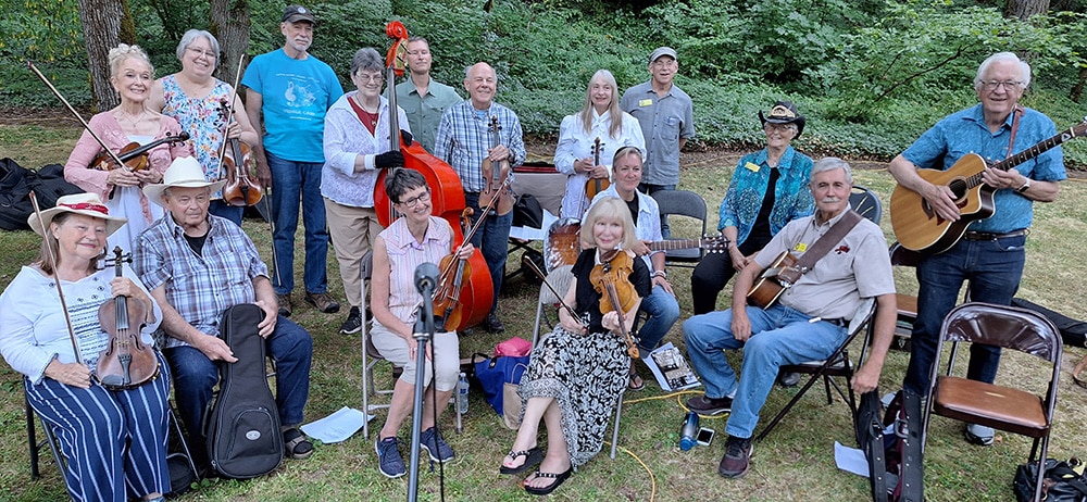 Old time fiddlers outside the Baker Cabin