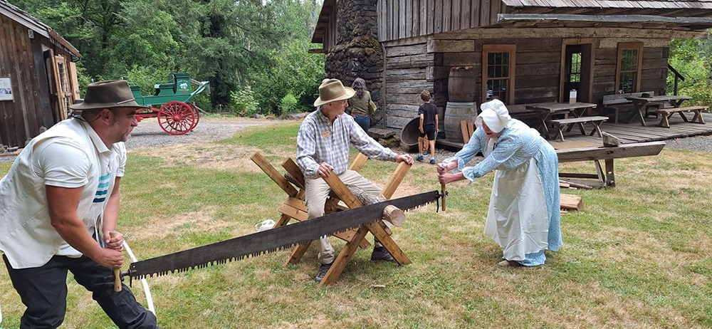 sawing wood at the Baker Cabin